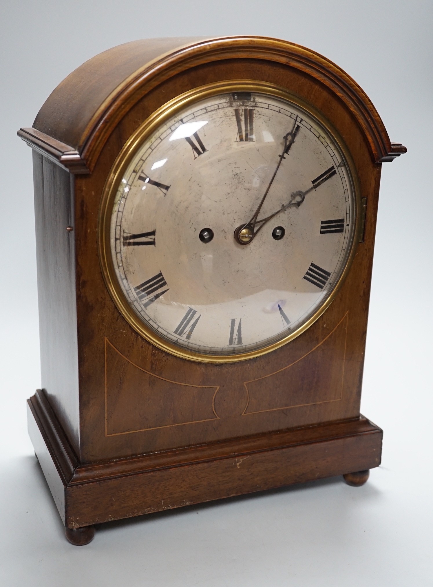 A late 19th/early 20th century mahogany mantel clock with German striking movement and convex silvered dial. 38cm tall